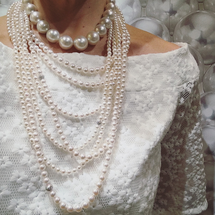 Pearls layered over a wedding gown.