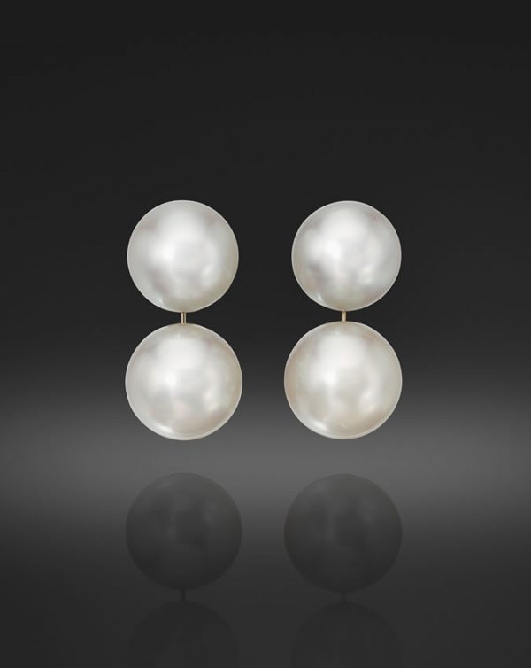 A Pair of South Sea Cultured Pearl Buttons, approximately 15 X 12mm, and a Pair of Round South Sea Cultured Pearls, 16.5mm, set in Platinum with Post backs.