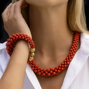 Model wears Corallia Collection. The natural color of our Bayadére Sardinian Coral