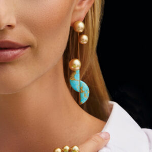 Model wearing golden south sea pearl sonoran turquoise earrings
