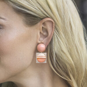 Woman wearing angel skin sunset earrings