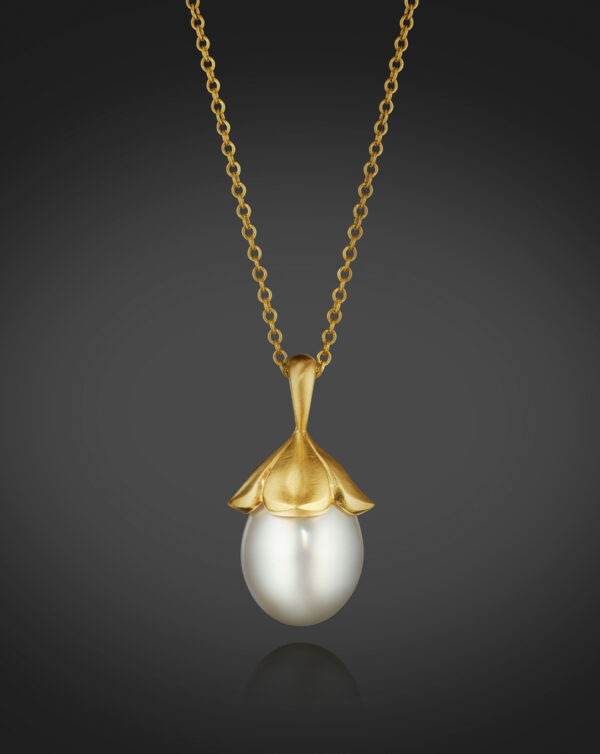 A magnificent South Sea Cultured Pearl Drop, approximately 17.0 X 14.0mm, is topped with “petals” of 18K Yellow Gold. 16” chain.