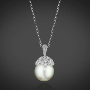 A single South Sea Cultured Pearl, approximately 14.0mm, is capped with Diamond “petals” totaling 1.65 carats. In 18K White Gold, 16” chain.