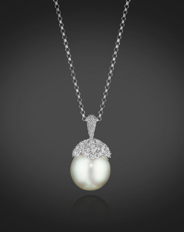 A single South Sea Cultured Pearl, approximately 14.0mm, is capped with Diamond “petals” totaling 1.65 carats. In 18K White Gold, 16” chain.