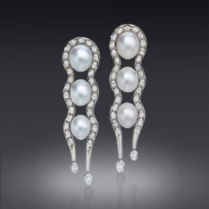 These long and luscious Earrings feature 3 pair of perfectly matched Gem South Sea Cultured Pearls, approximately embraced by shapely lines of sparkling Oval Diamonds