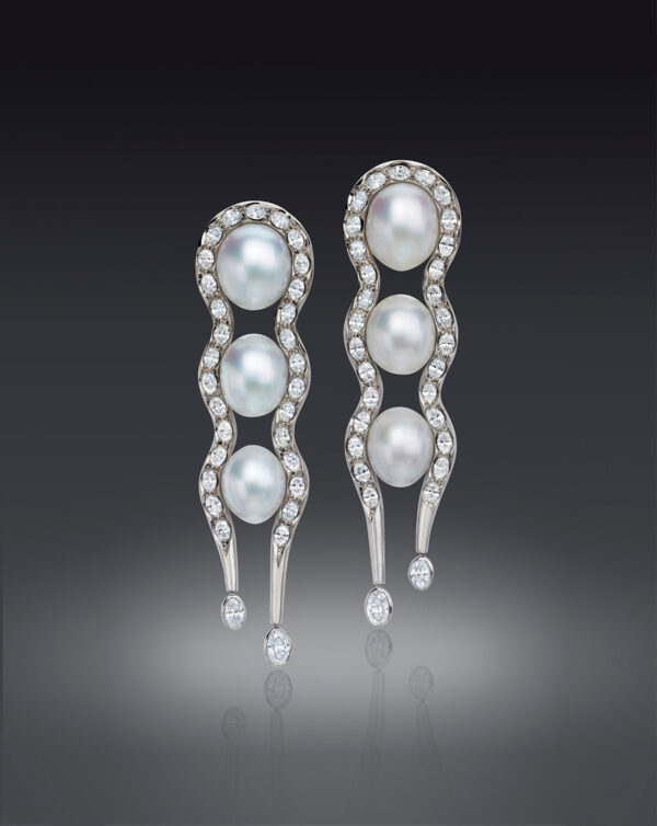 These long and luscious Earrings feature 3 pair of perfectly matched Gem South Sea Cultured Pearls, approximately embraced by shapely lines of sparkling Oval Diamonds